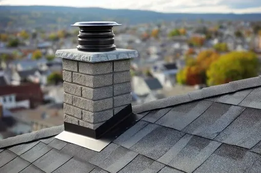 Masonry chimney with a decorative cap on a Burbank roof